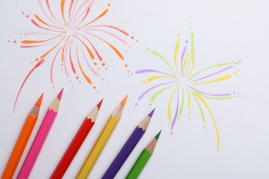 Photo of Abstract drawing and colorful pencils on white background, top view