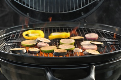 Photo of New modern barbecue grill with different vegetables, closeup