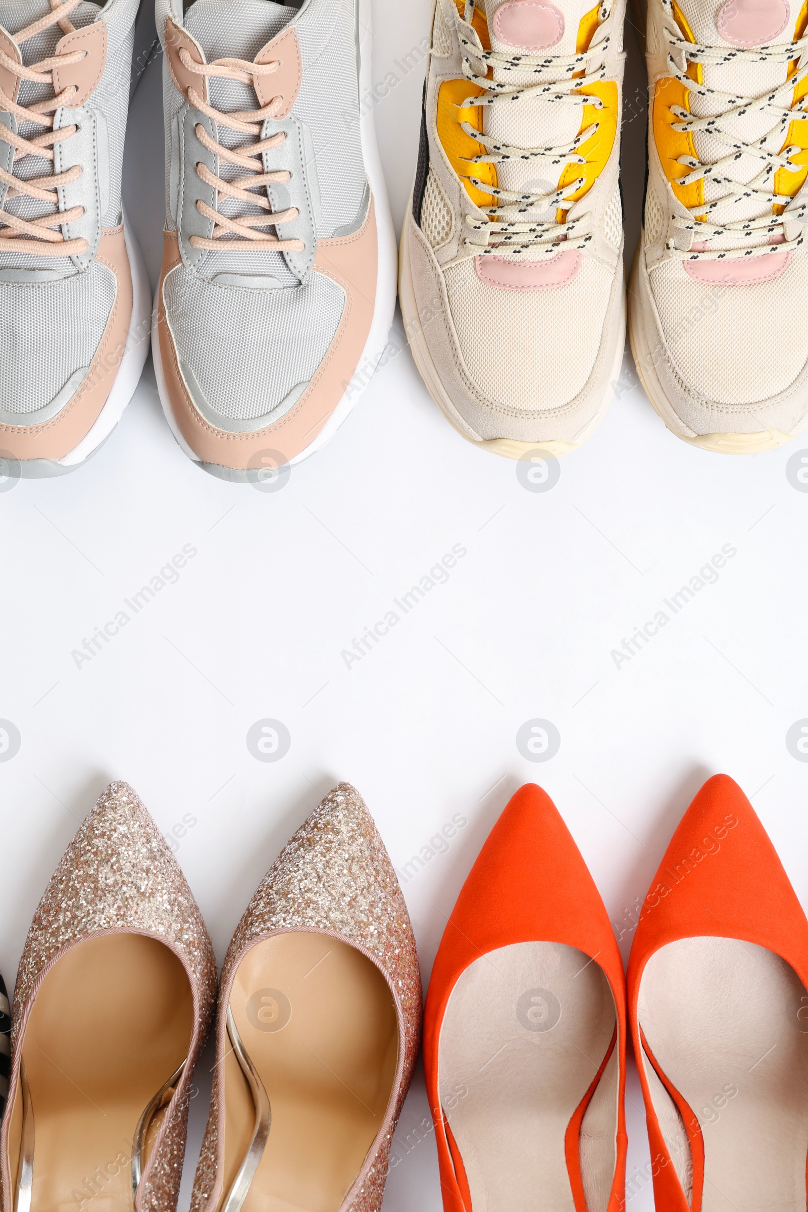 Photo of Frame of different shoes on white background, top view with space for text