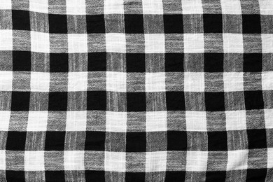 Black checkered tablecloth as background, top view