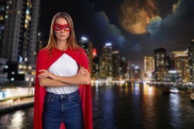 Image of Confident woman wearing superhero costume and beautiful cityscape in night on background