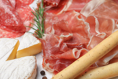 Photo of Tasty prosciutto served on table, closeup view 