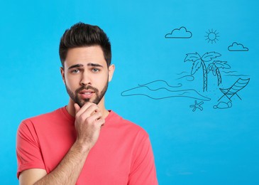 Young man dreaming about vacation on blue background