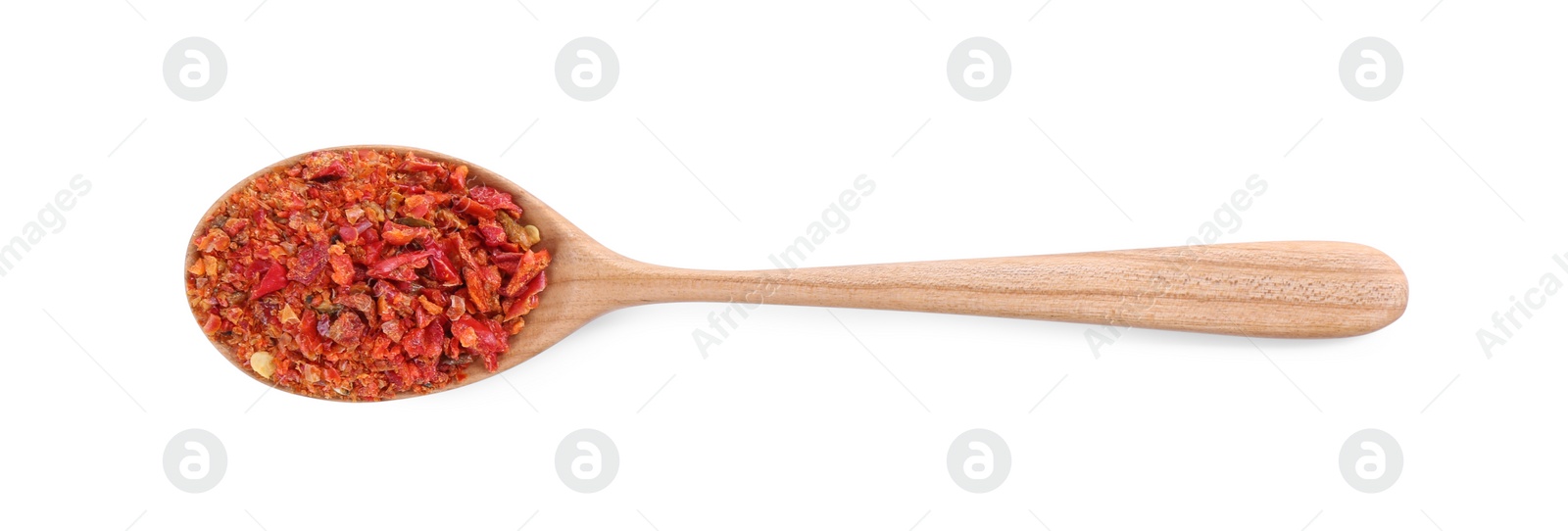 Photo of Aromatic spice. Red chili pepper flakes in spoon isolated on white, top view