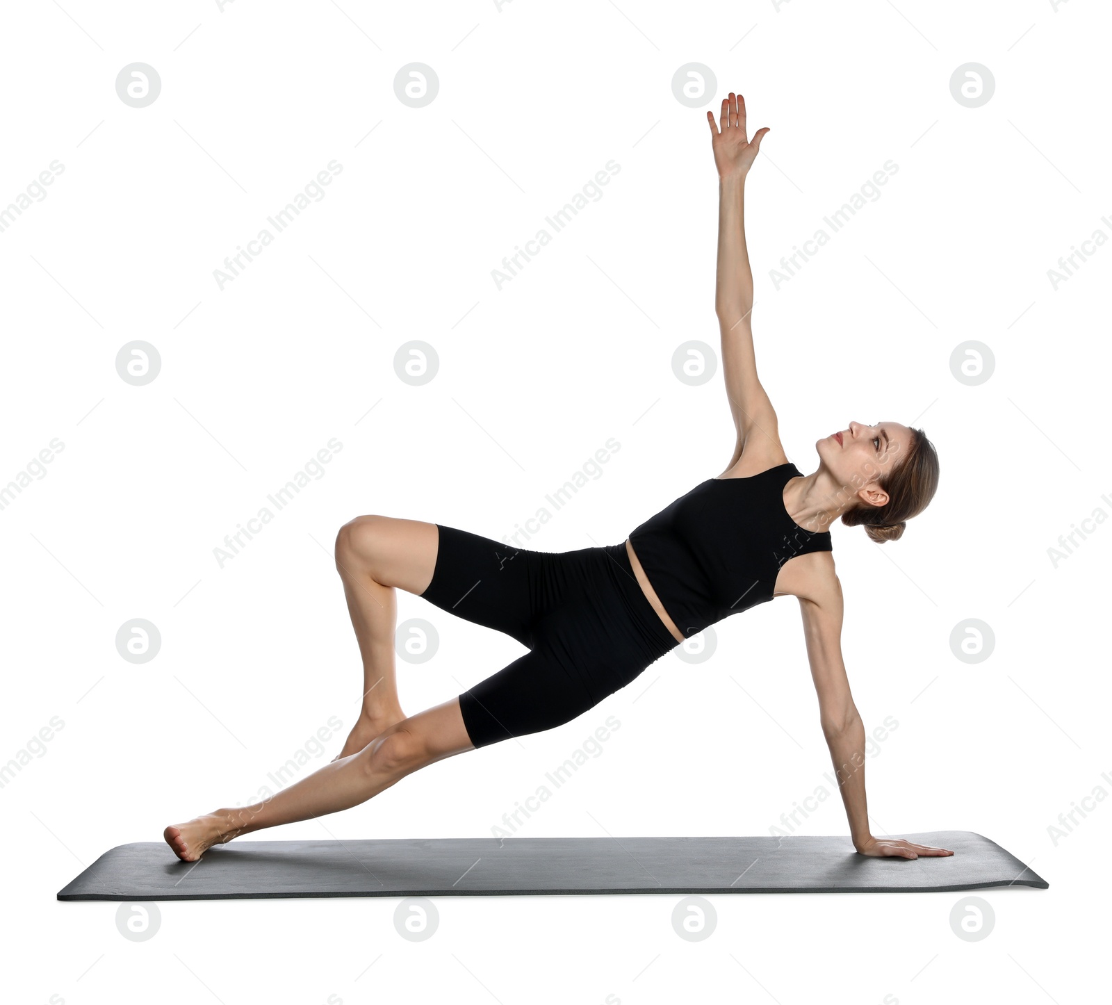 Photo of Young woman in sportswear practicing yoga on white background