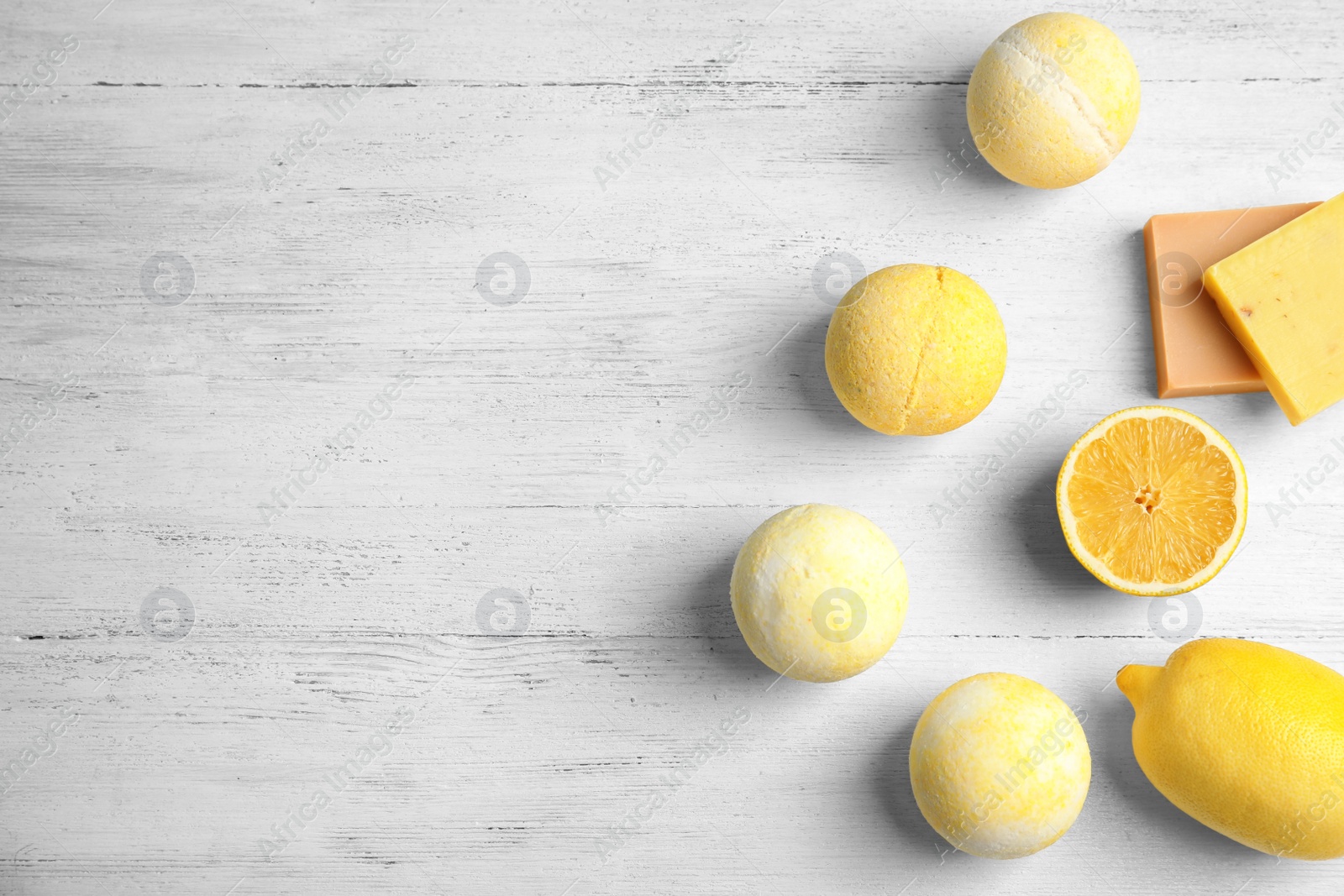 Photo of Flat lay composition with bath bombs and space for text on white wooden background