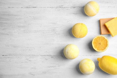 Flat lay composition with bath bombs and space for text on white wooden background