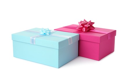 Photo of Pink and light blue gift boxes with bows on white background