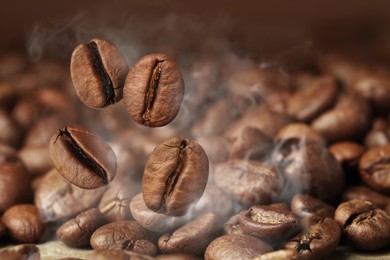 Aromatic roasted coffee beans and steam, closeup