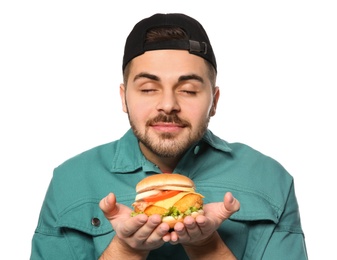 Photo of Handsome man with tasty burger isolated on white