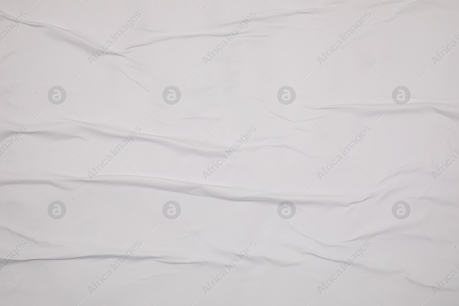 Photo of Top view of white creased blank poster as background, closeup