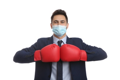 Photo of Businessman with protective mask and boxing gloves on white background. Strong immunity concept