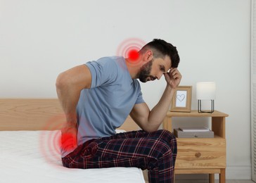 Image of Man suffering from back pain after sleeping on uncomfortable mattress at home