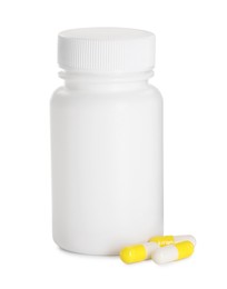 Photo of Antibiotic pills and bottle isolated on white