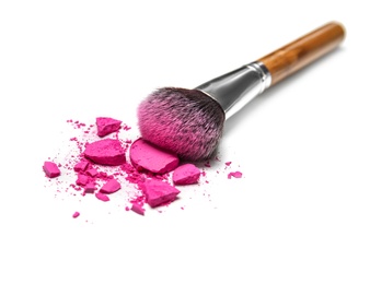 Photo of Makeup brush and crushed cosmetic product on white background