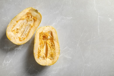 Photo of Raw cut spaghetti squash and space for text on gray background, top view