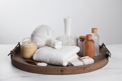 Spa composition with care products on white marble table