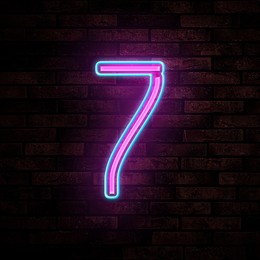 Image of Glowing neon number 7 sign on brick wall