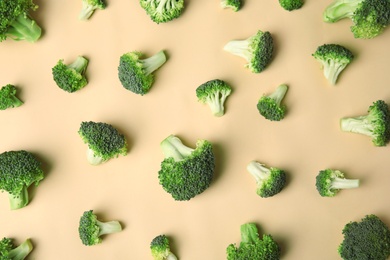 Photo of Flat lay composition with fresh green broccoli on color background