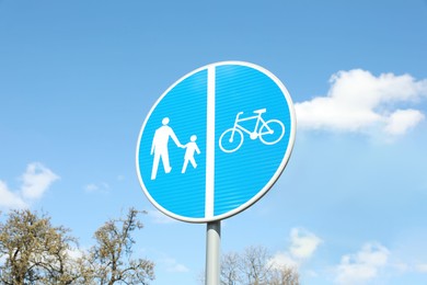 Photo of Traffic sign Compulsory Track For Pedestrians and Bicycles outdoors on sunny day, low angle view