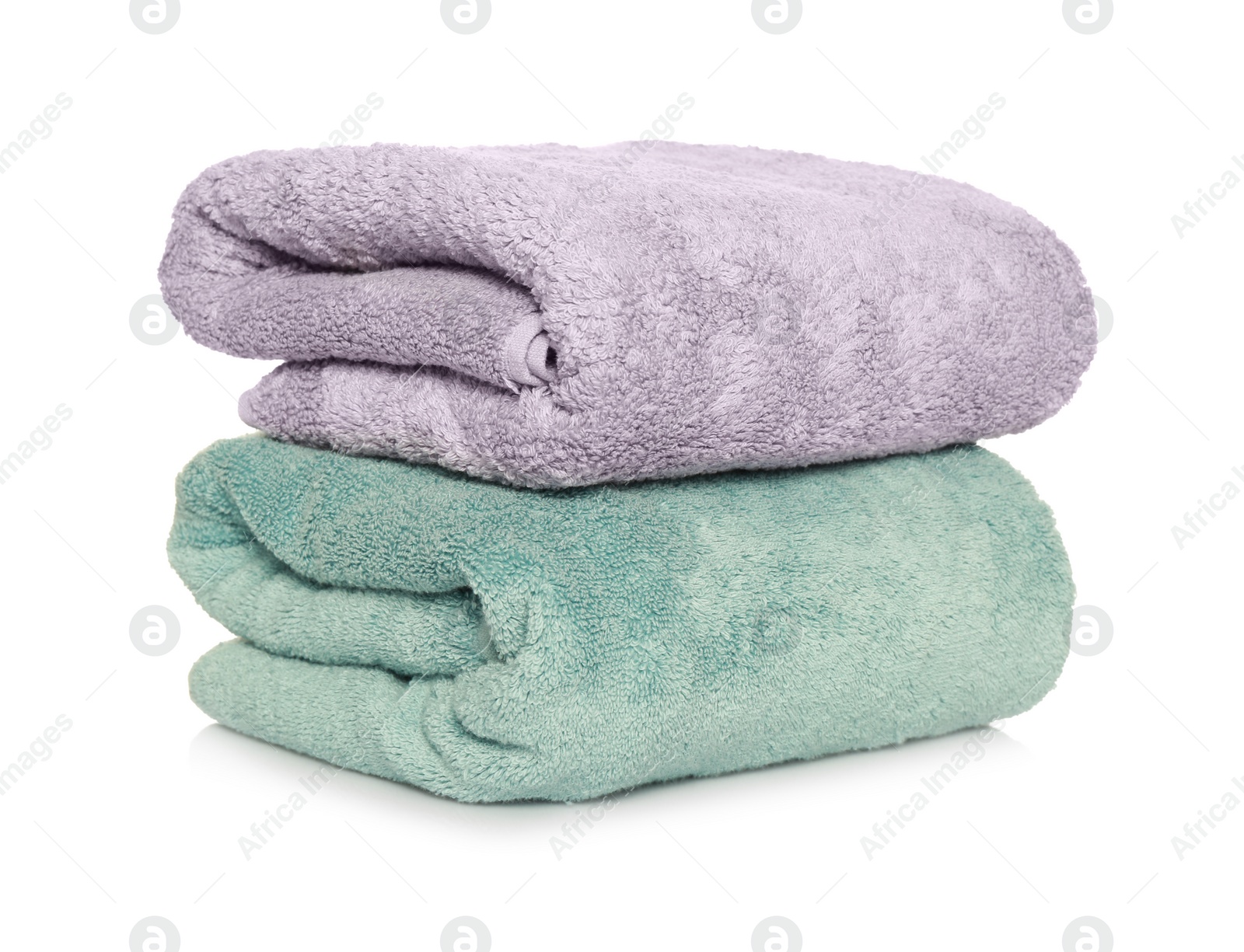 Photo of Folded soft terry towels on white background