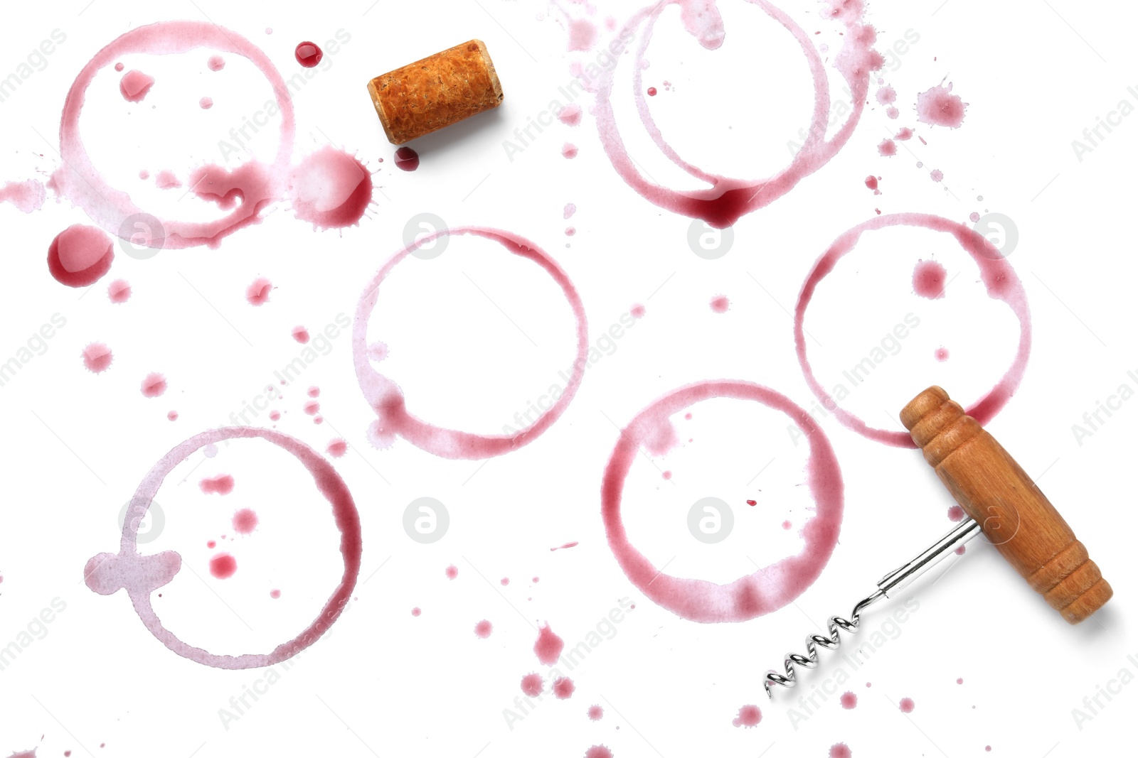 Photo of Red wine rings, drops, bung and corkscrew on white background, top view