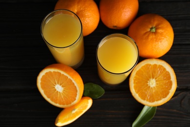 Photo of Composition with orange juice and fresh fruit on wooden background, above view