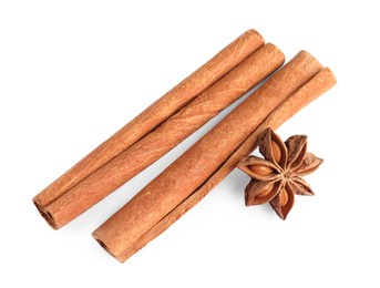 Photo of Cinnamon sticks and anise star isolated on white, above view