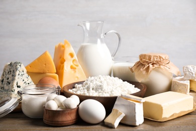 Different delicious dairy products on wooden table