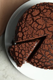 Photo of Delicious chocolate truffle cake on grey table, top view