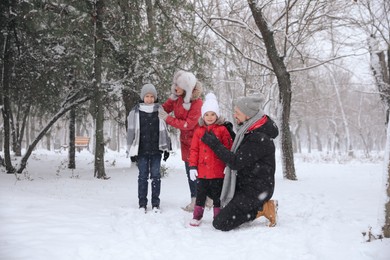 Family spending time outside on winter day. Christmas vacation