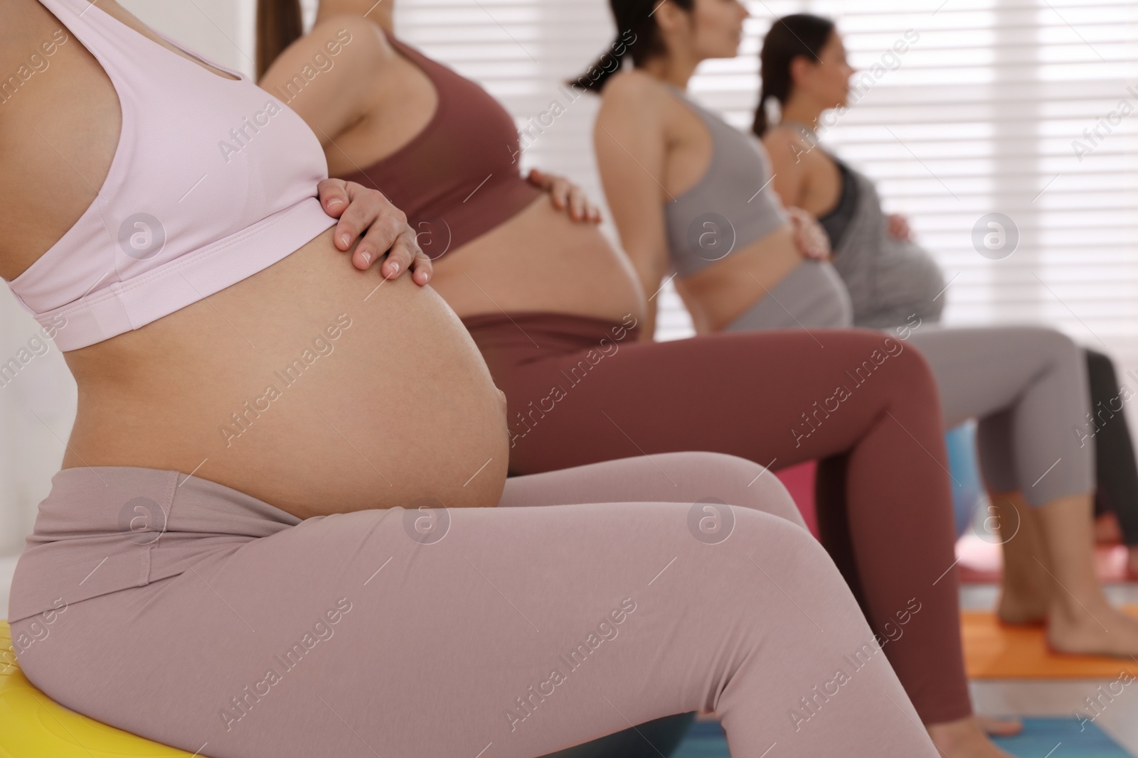 Photo of Group of pregnant women in gym, closeup. Preparation for child birth