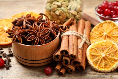 Photo of Composition with mulled wine ingredients on wooden table, closeup