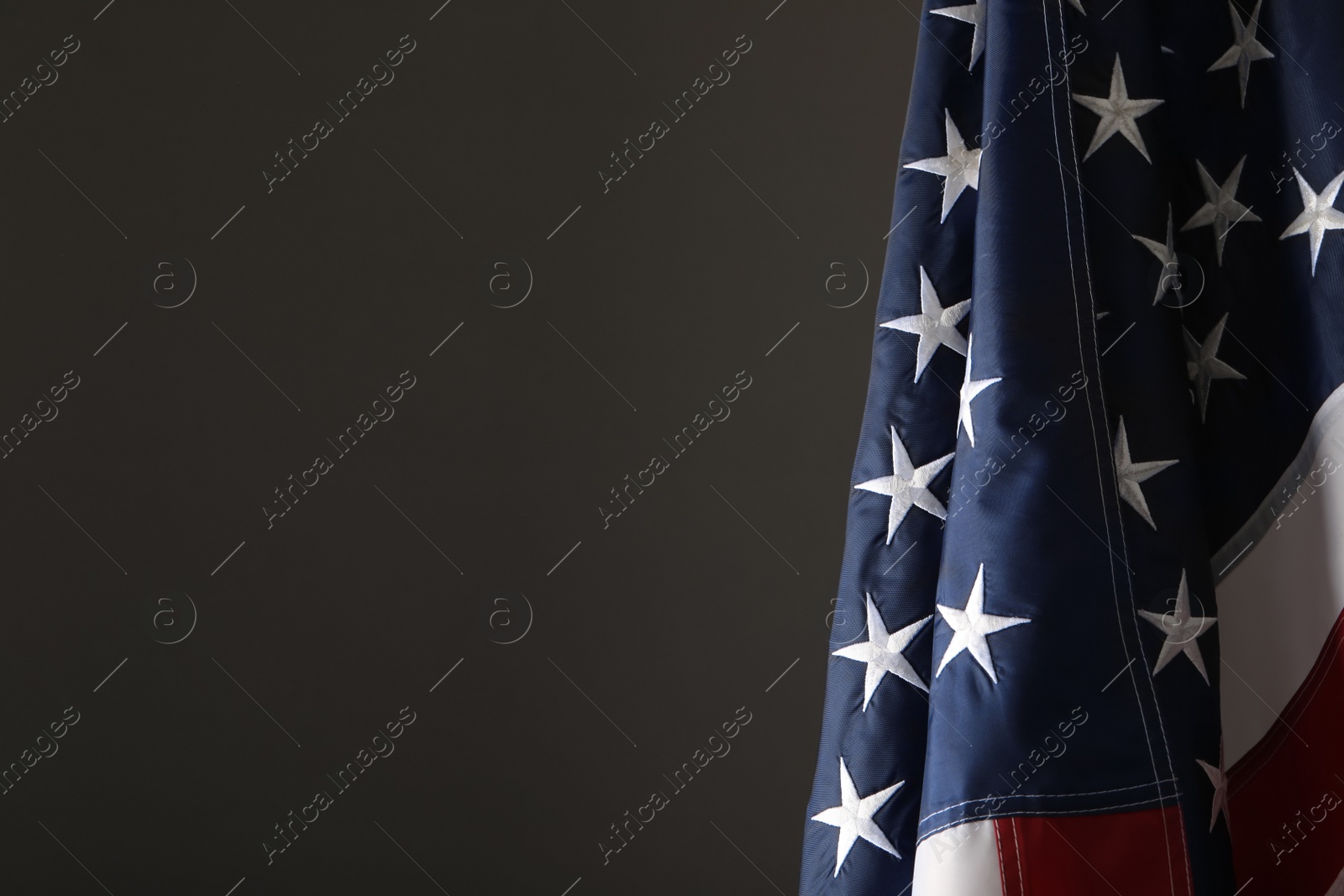 Photo of America flag on grey background, closeup with space for text. Memorial Day