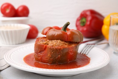 Photo of Delicious stuffed bell pepper served on light table