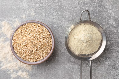 Photo of Quinoa flour in sieve and bowl with seeds on light grey table, flat lay