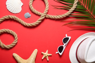 Flat lay composition with rope and beach objects on color background