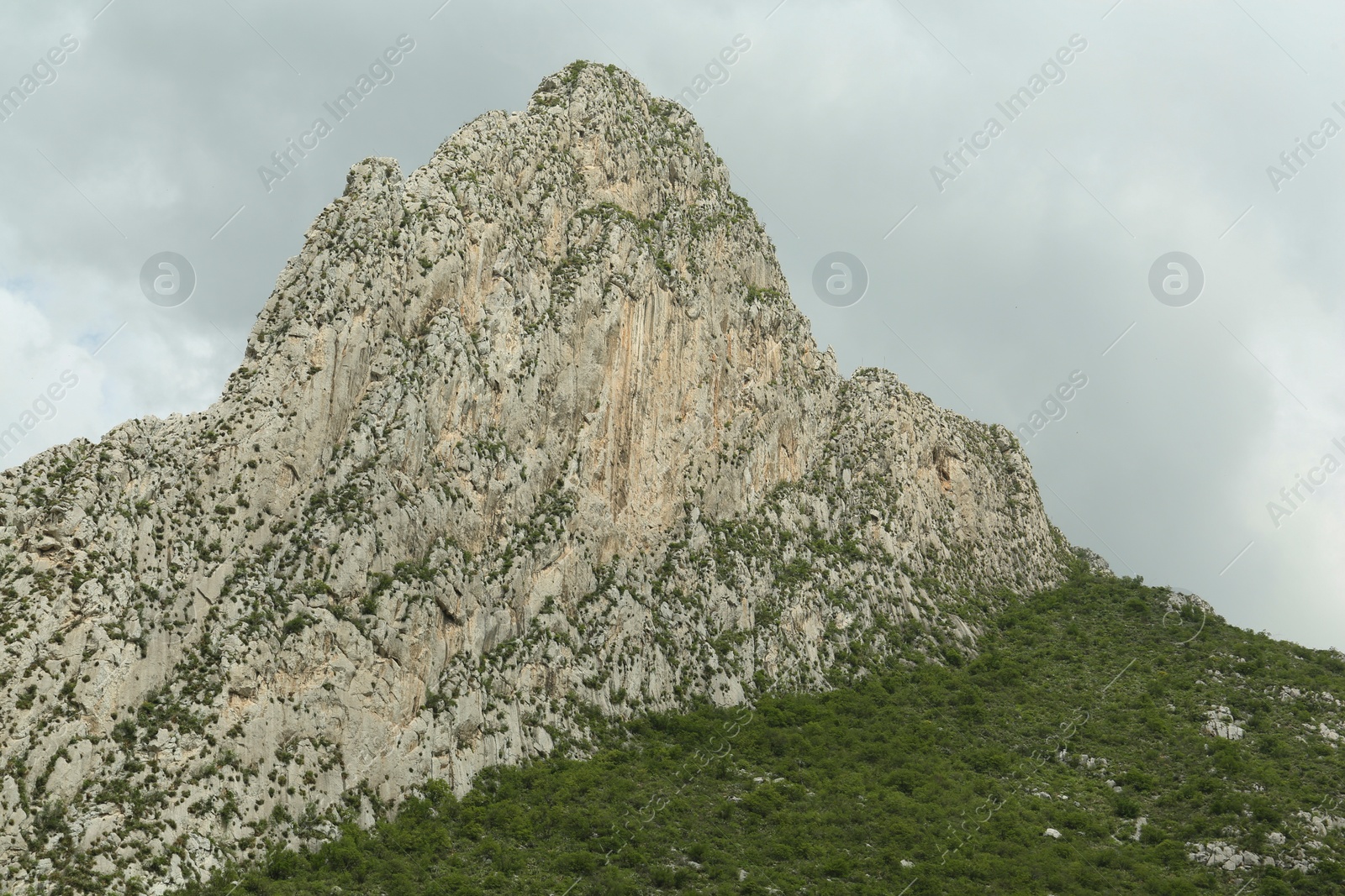 Photo of Picturesque landscape with high mountains under cloudy sky