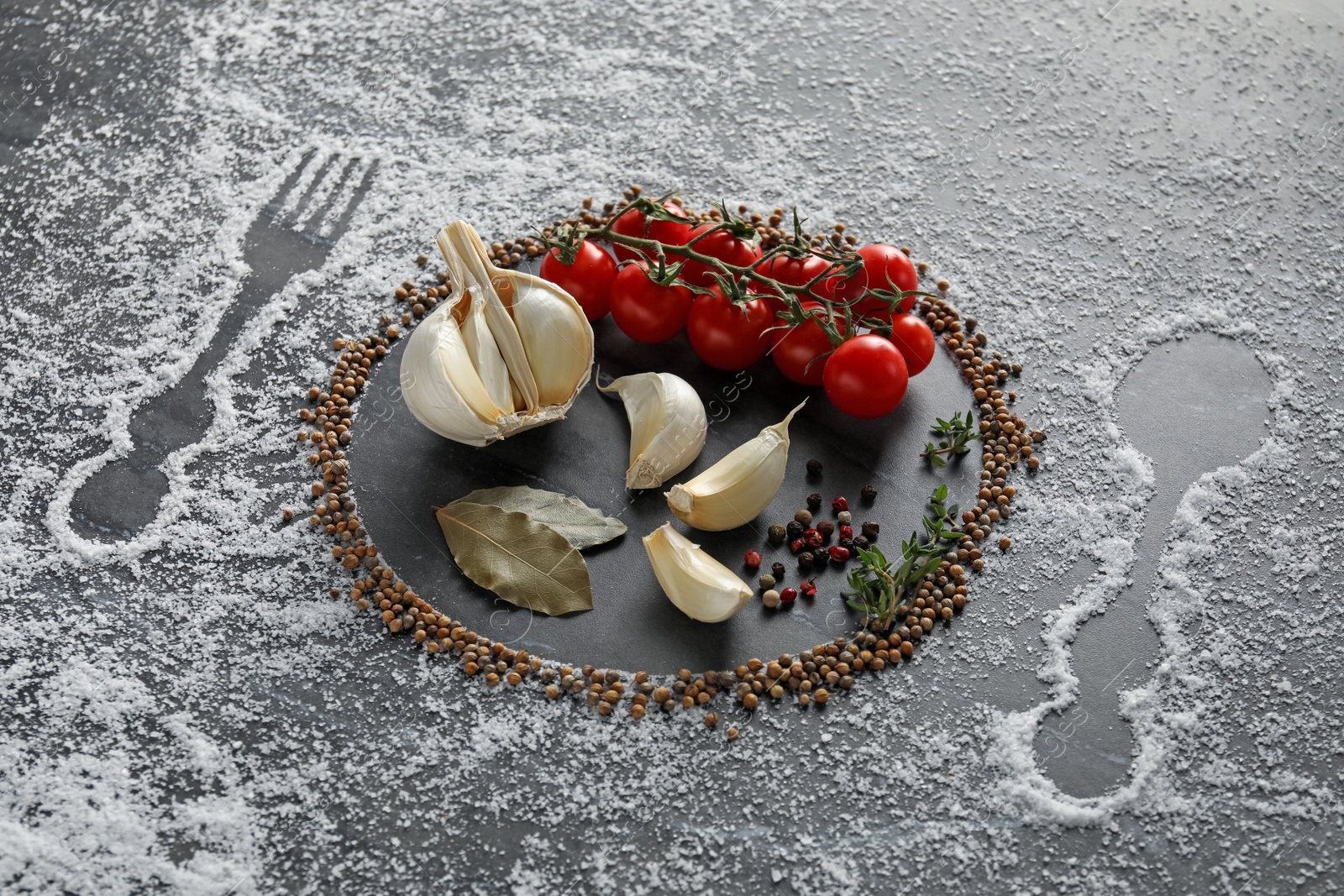 Photo of Different spices and silhouettes of cutlery and plate on grey marble background