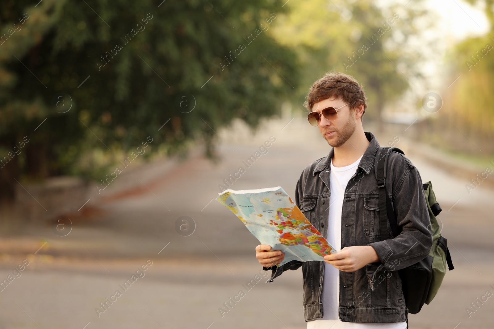 Photo of Traveler with world map on city street