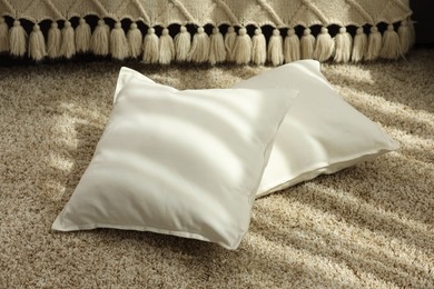 Soft white pillows on floor in room