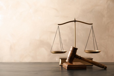 Photo of Wooden gavel with scales of justice and book on table. Law concept