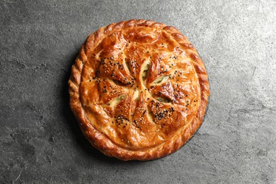 Photo of Tasty homemade pie with filling on grey table, top view