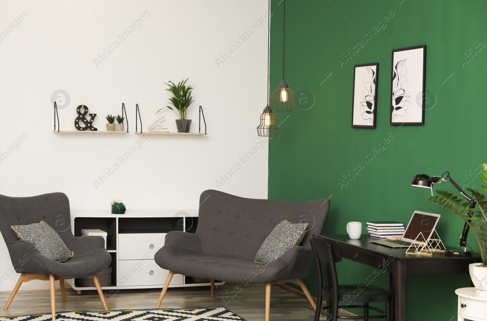 Photo of Modern living room interior with workplace near green wall