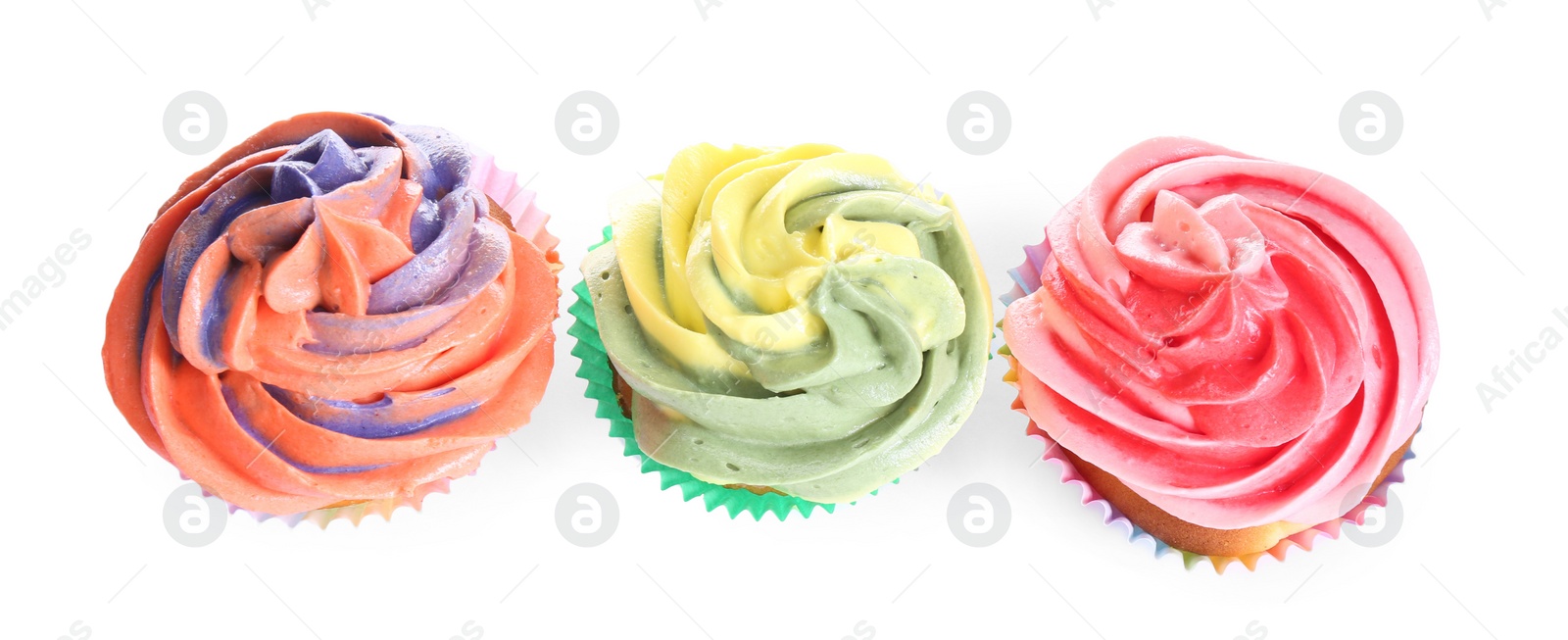 Photo of Different tasty cupcakes with cream isolated on white, top view