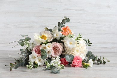 Photo of Bouquet of beautiful flowers on wooden table