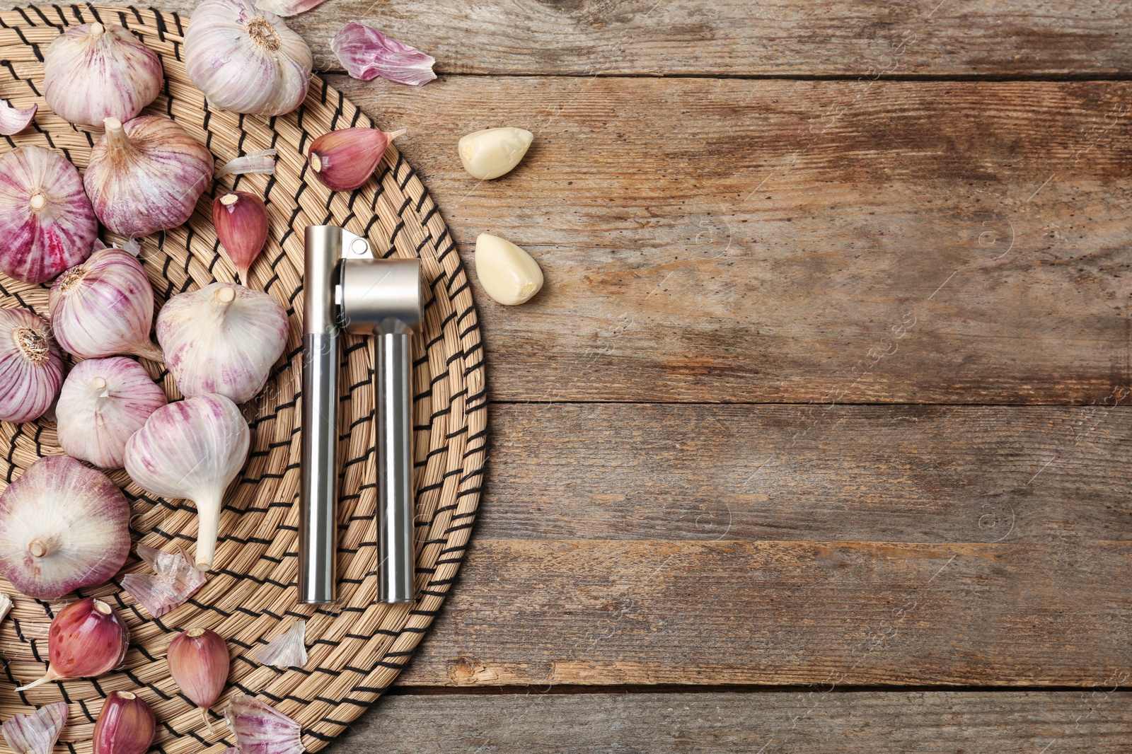 Photo of Flat lay composition with garlic press on wooden table