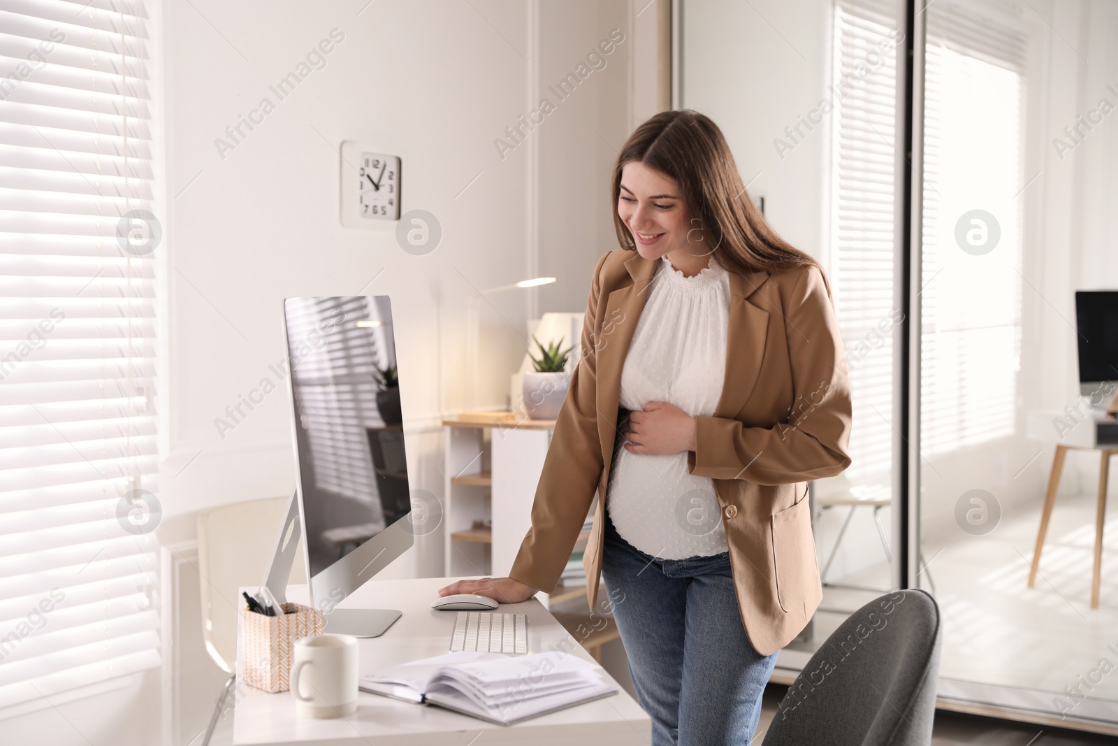 Photo of Pregnant woman working at home. Maternity leave