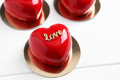 Photo of St. Valentine's Day. Delicious heart shaped cakes on white wooden table, closeup