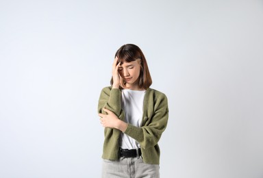 Photo of Portrait of stressed young girl on white background